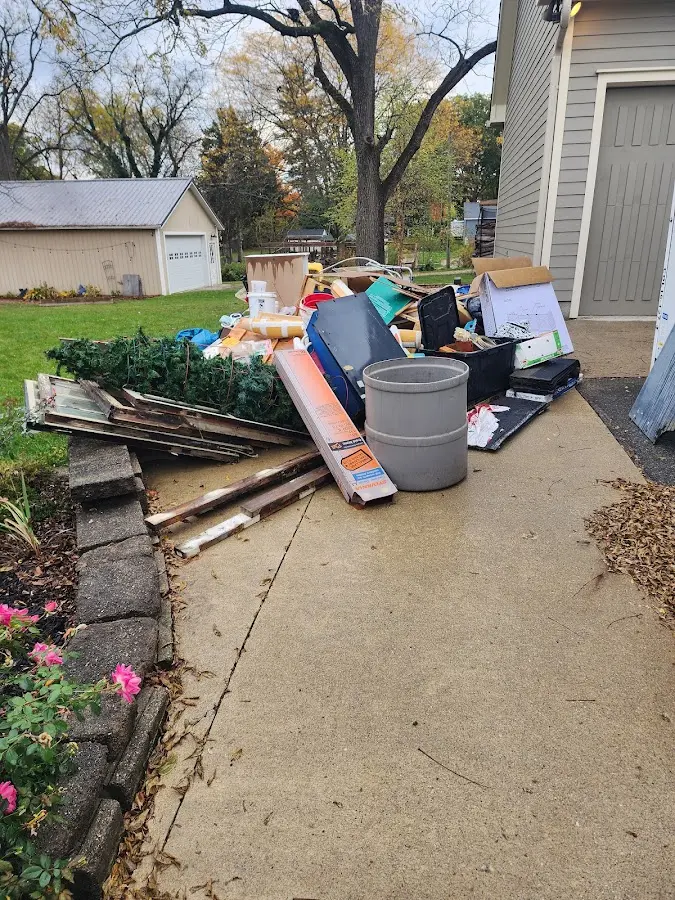 Dumpster being loaded with debris for Roofing Dumpster Rental in Etowah